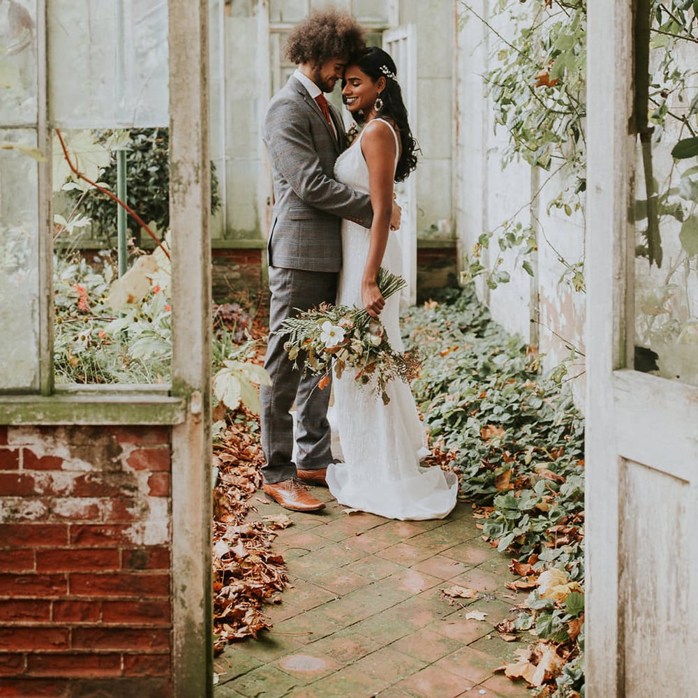 Bride and groom portrait in the greenhouse at Hooton Pagnell Hall