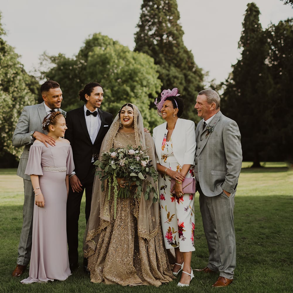 Family portraits at multicultural wedding 