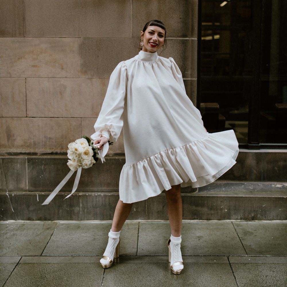 Loose fitting wedding dress with gathered hem and long sleeves by Moon Child Bridal and Jean Jackson Couture 