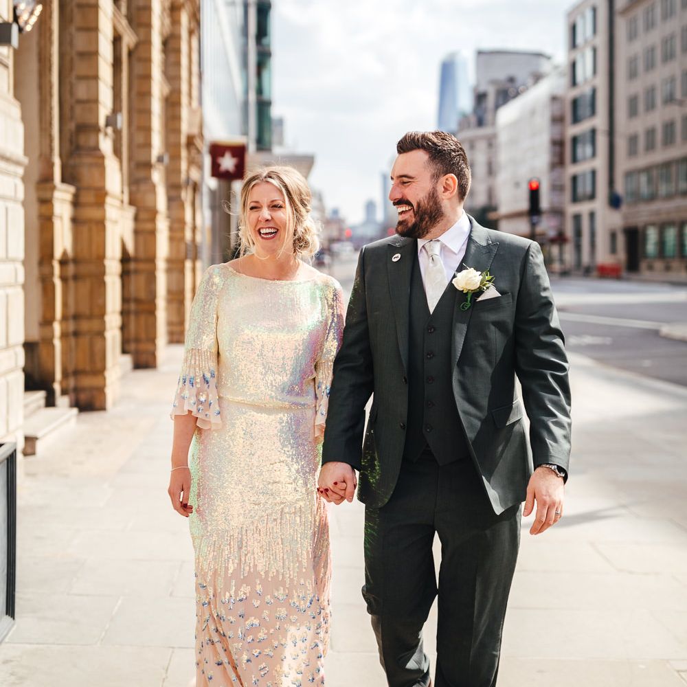 Bride & groom walk together through London