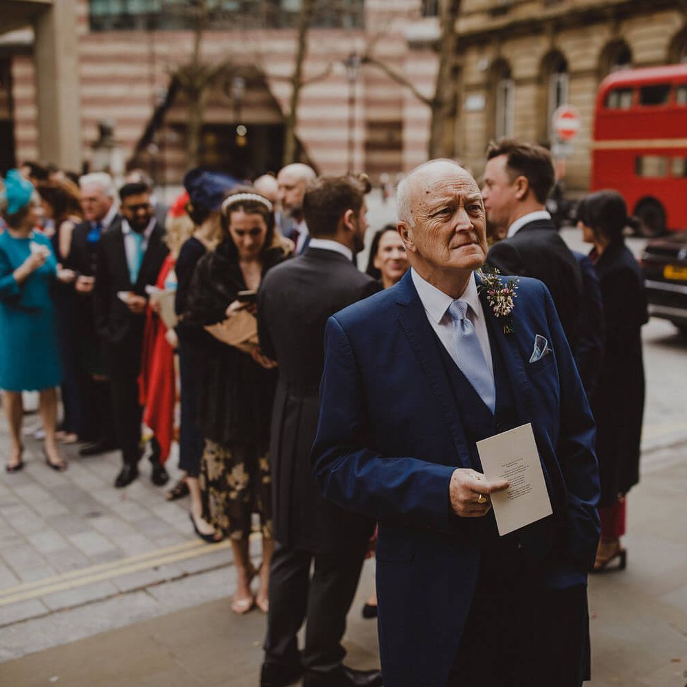 Wedding guests waiting outside London wedding venue