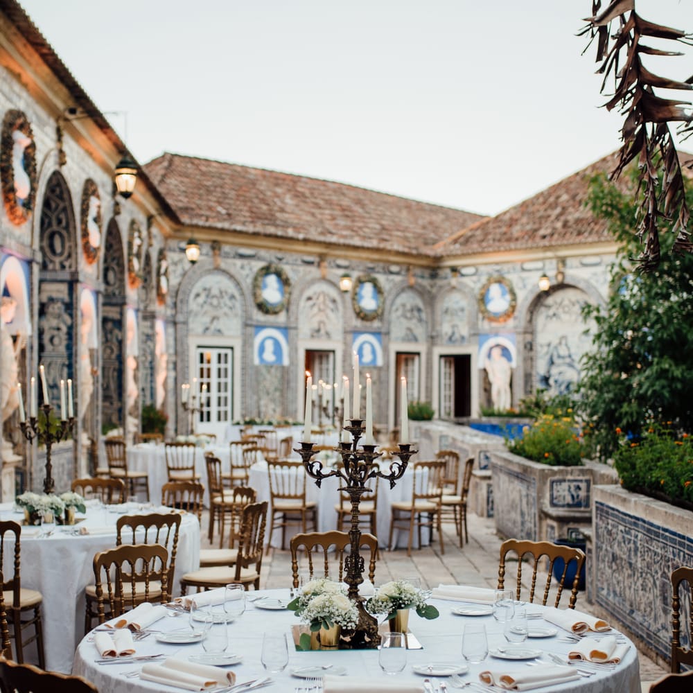 Outdoor wedding reception in Lisbon surrounded by colourful tiled buildings
