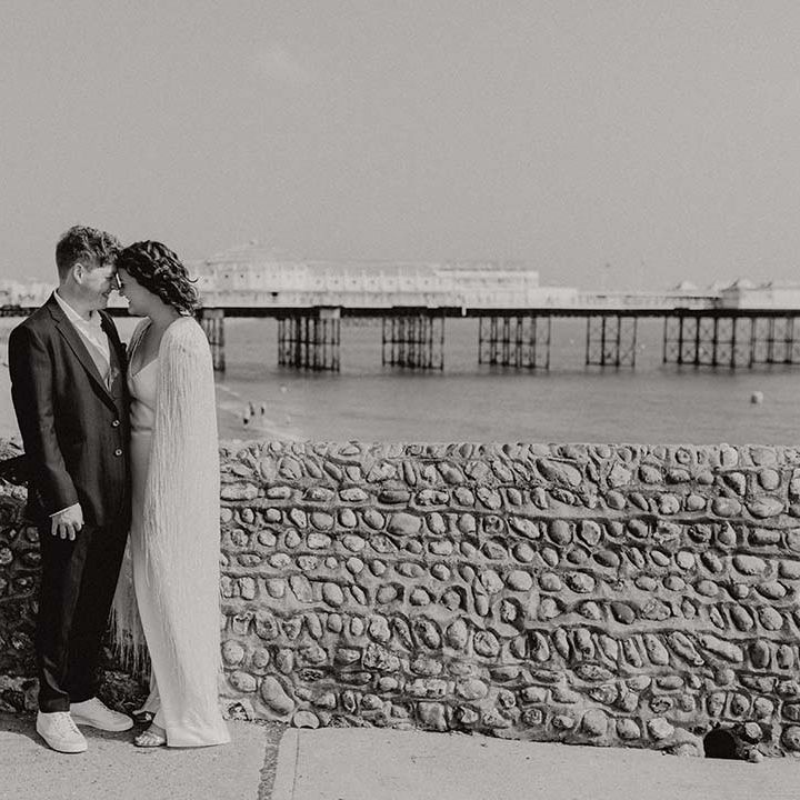 Black & white image of bride & groom near Brighton seafront