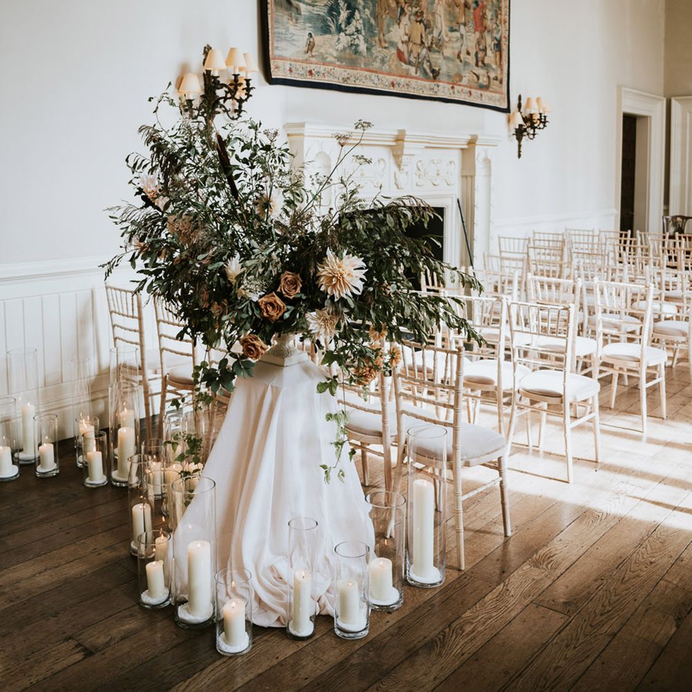 Wedding ceremony flowers and decor with dahlias, foliage and candles 