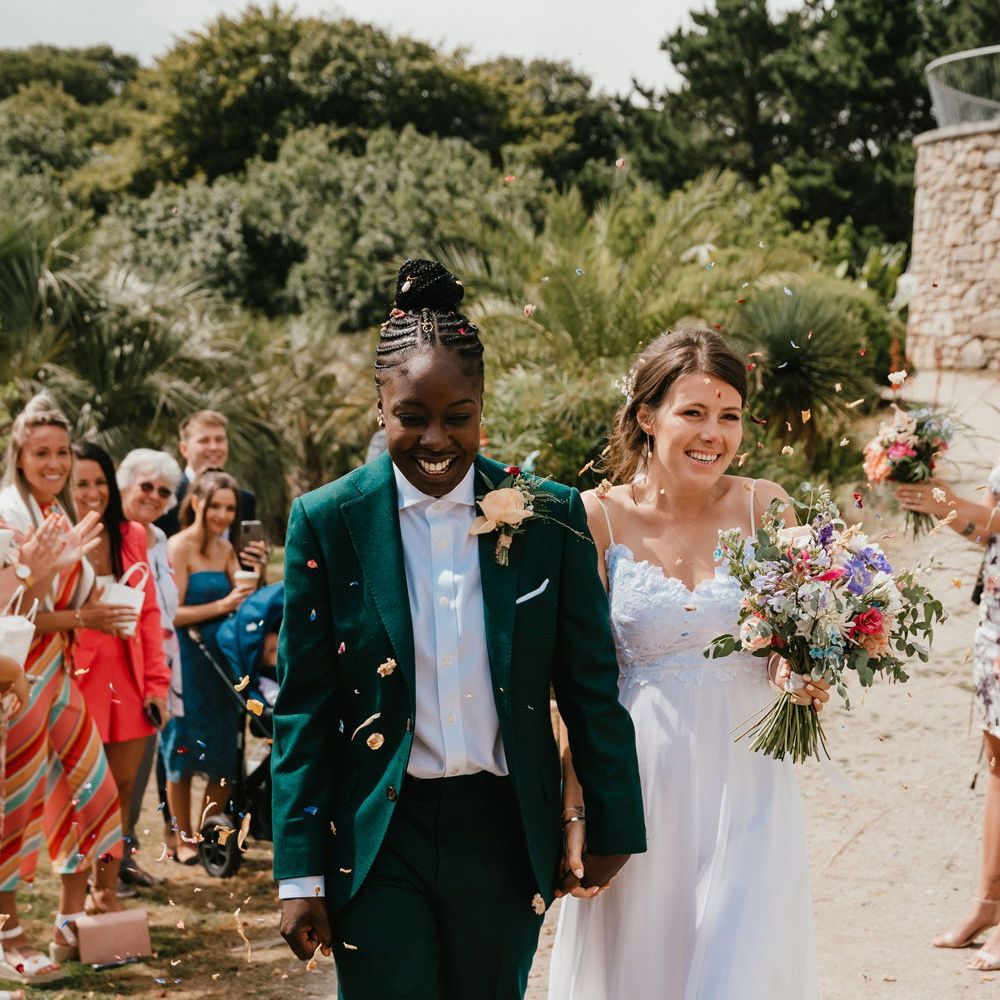 Confetti moment at Lesbian wedding with two brides in a green wedding suit and Grace Loves Lace wedding dress