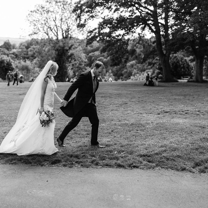 Bride walks with the groom around Bristol on their wedding day 