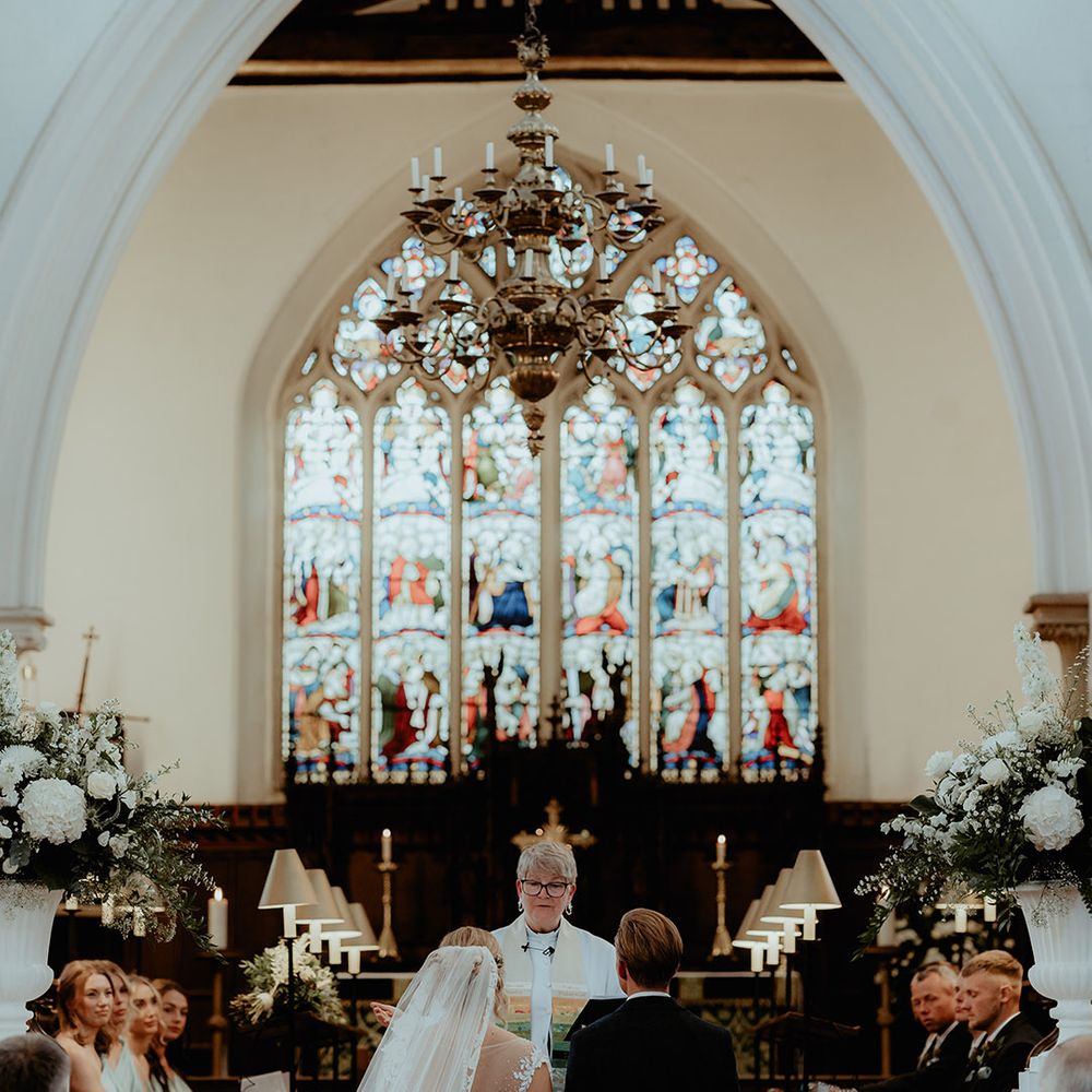 Bride and groom stand as they participate in their church wedding ceremony 