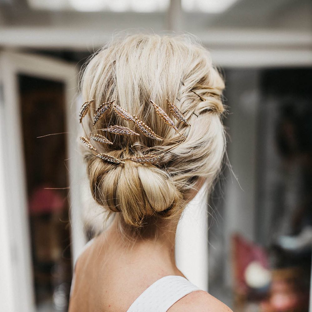 Bridal hair styling with golden leaf bridal hair accessory