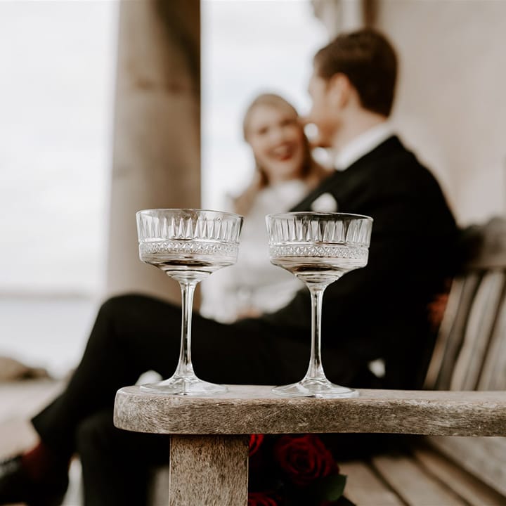 Pretty detailed champagne coupe glasses for the bride and groom on their wedding day 