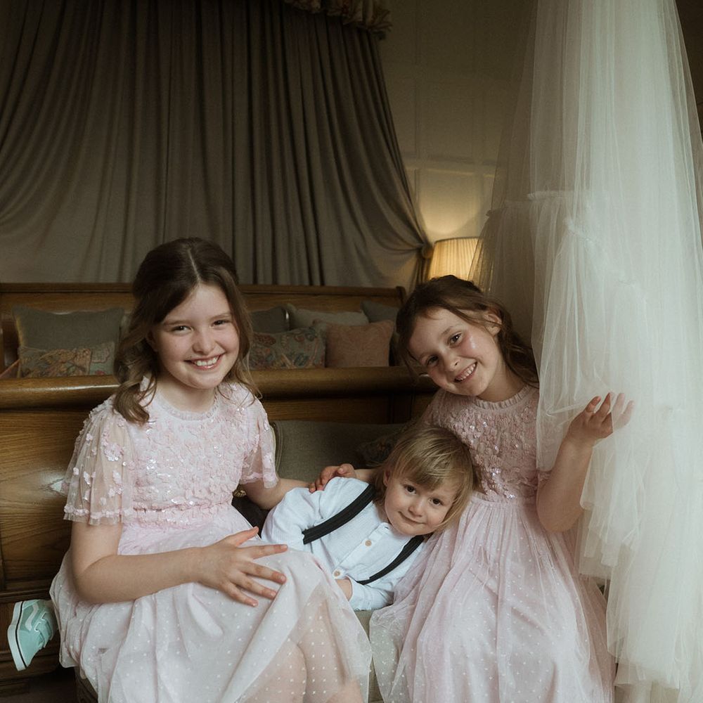 Flower girls in pretty pink Needle & Thread flower girl dresses with little page boy 