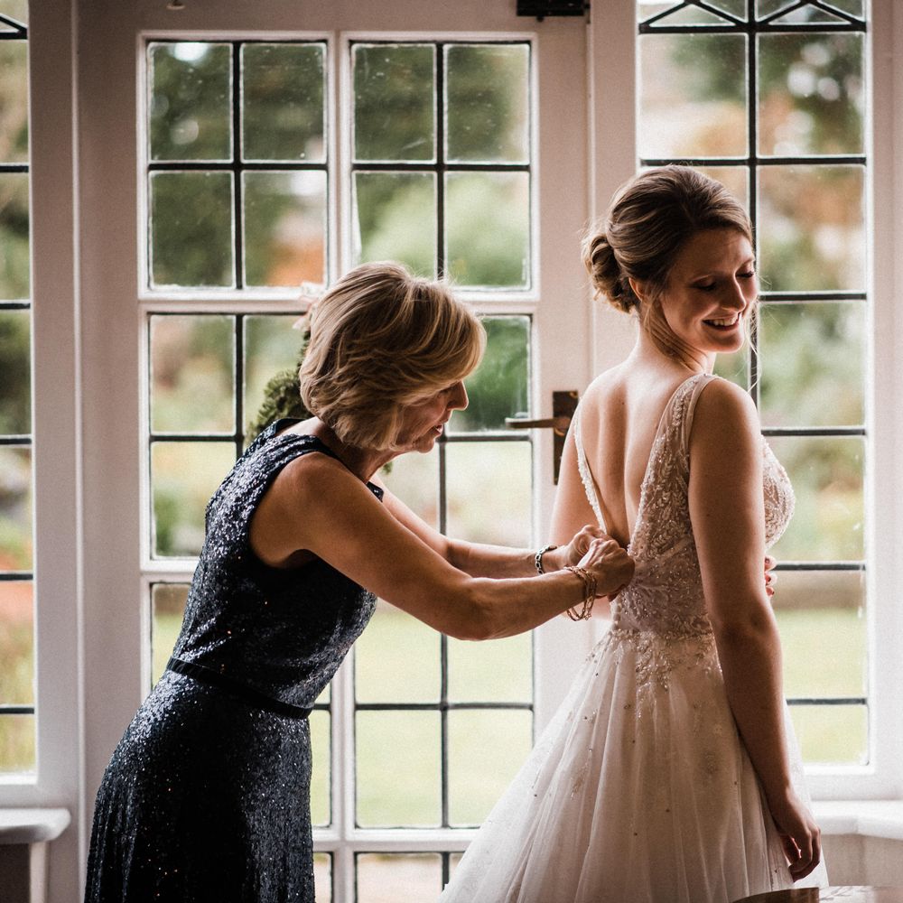 Bride has her dress up done up on the morning of her wedding
