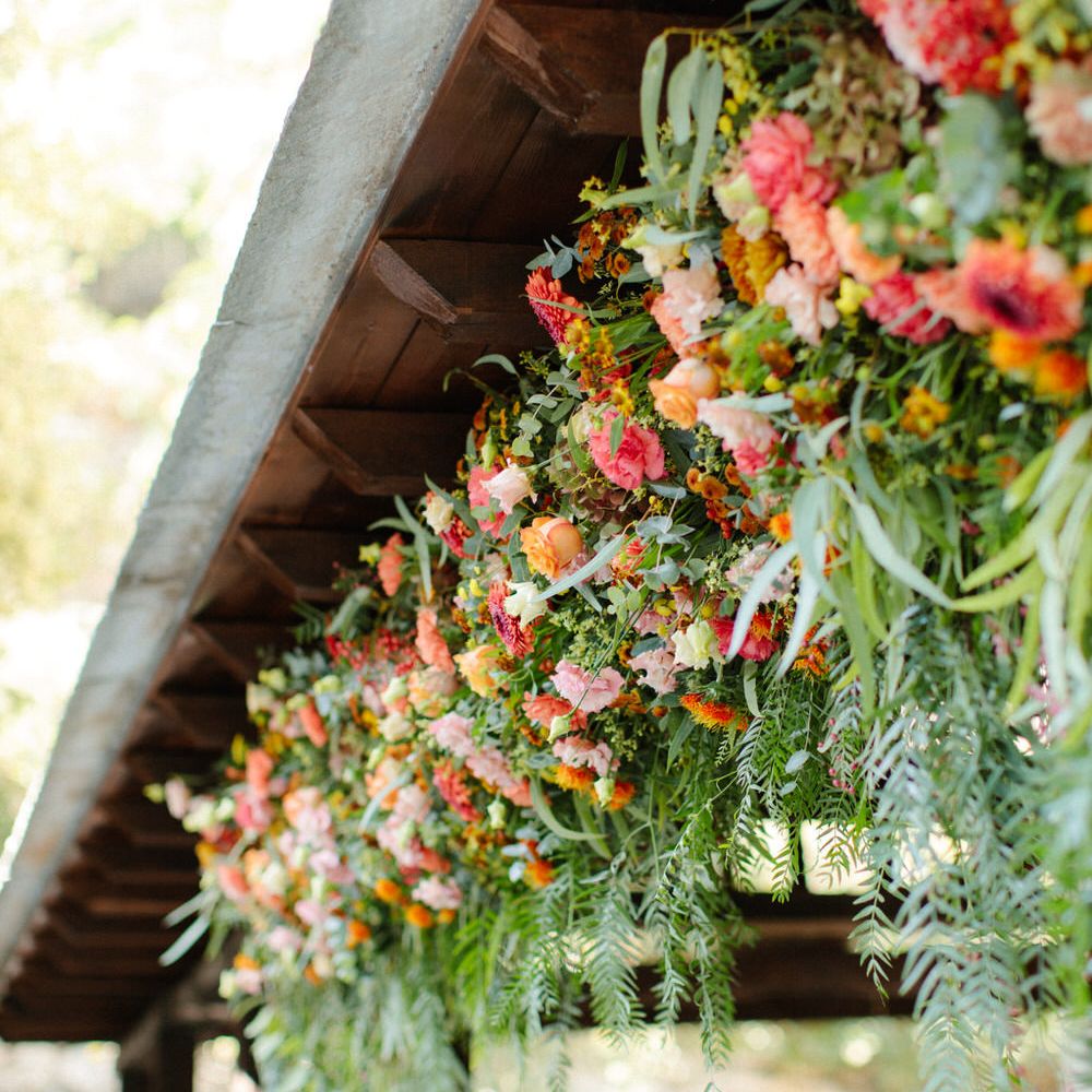 Pink, orange and red hanging flower bouquets for a destination wedding in Greece