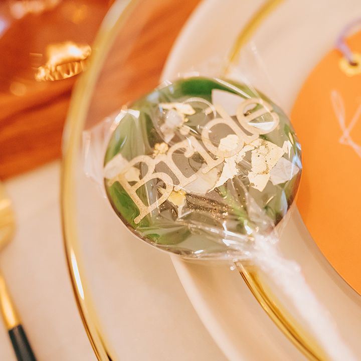Green and gold speckled lollipop wedding favour 
