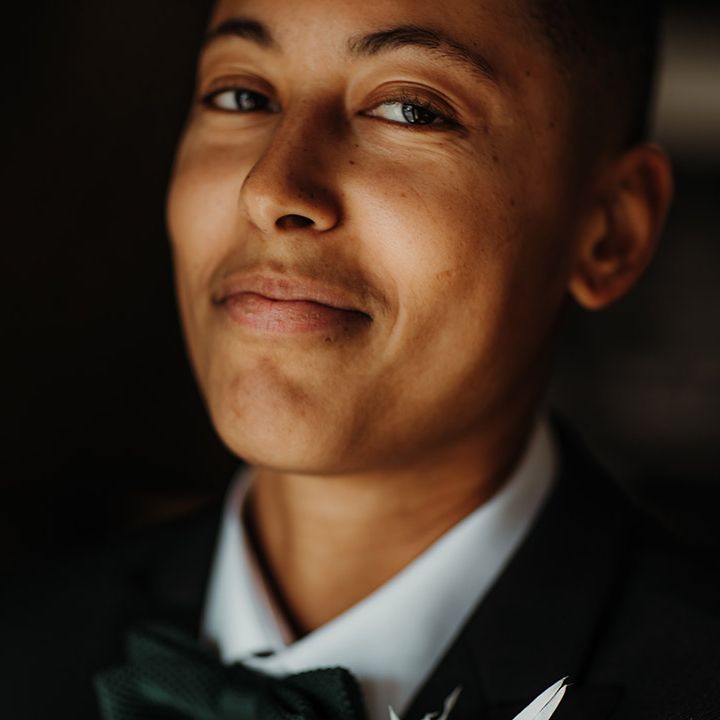 LGBTQI+ person with natural makeup and bow tie 