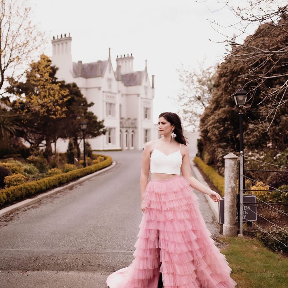 Bride in a pink ruffled wedding skirt and crop top at Ballykealey House wedding venue in Co. Carlow, Ireland
