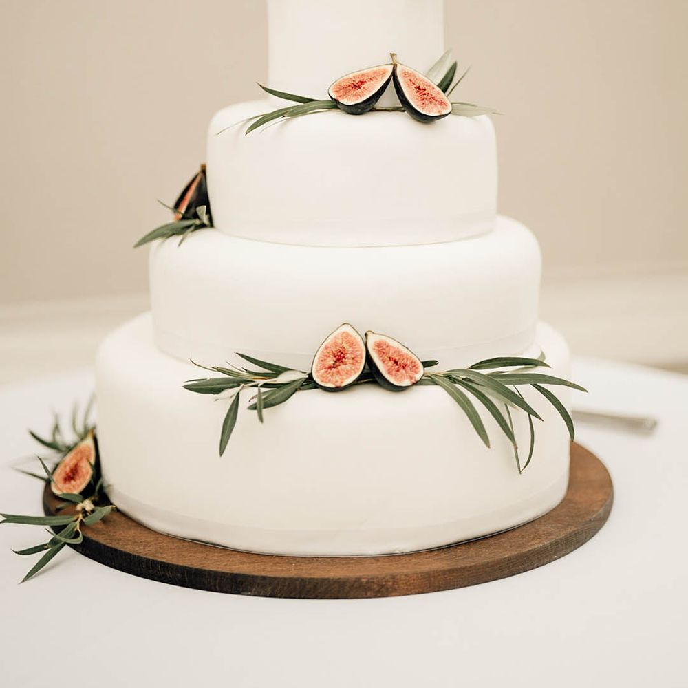 Four tier iced wedding cake with figs 