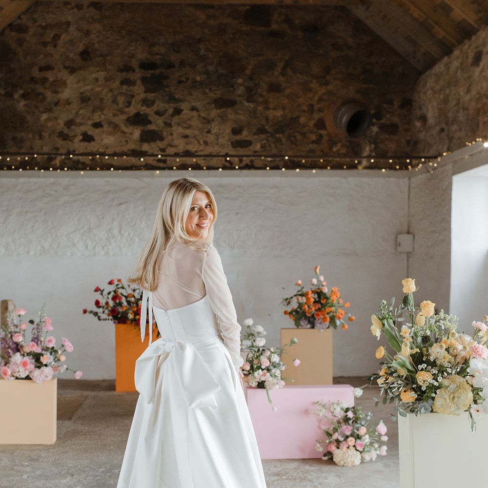 Bride wears a Jessica Bennett gown with bow detail on the back 