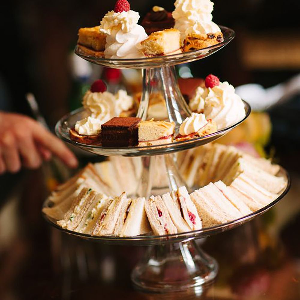 Afternoon tea stand with cakes and sandwiches by Lee Allen Photography 