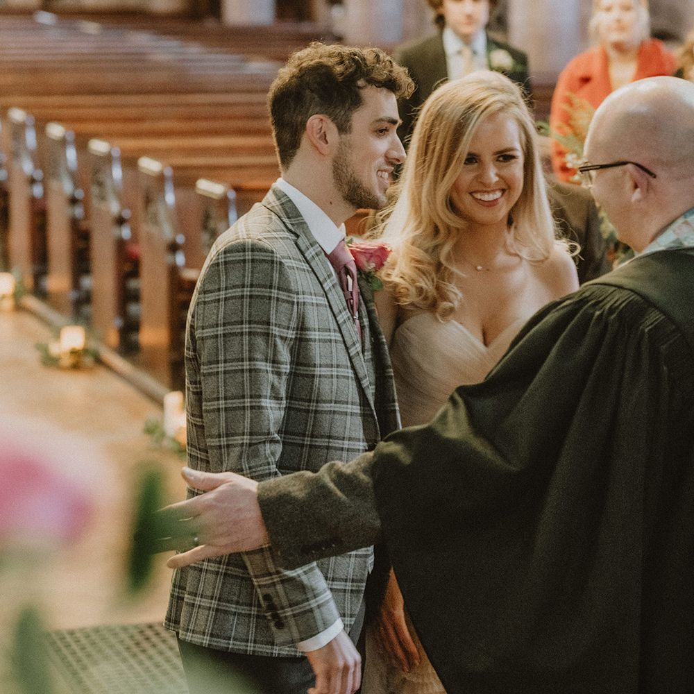 Bride and groom at church micro wedding in Watters blush wedding dress