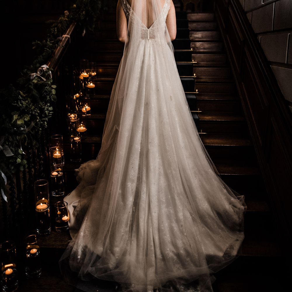 Bride stands on staircase of Davenport House