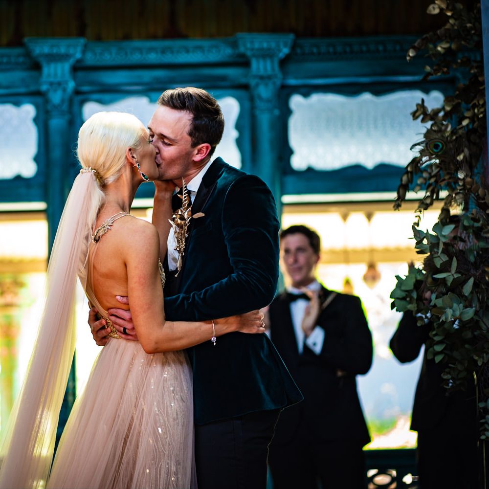 Bride and groom kiss at the altar