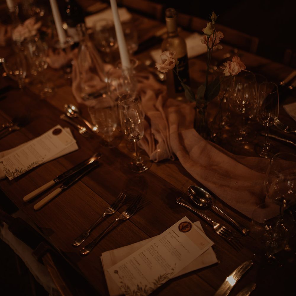 Romantic wedding table decor with taper candles and flower stems in vases 
