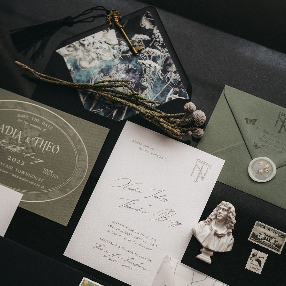 Green white and black wedding stationery suite with script font, vellum overlays, black envelopes and white wax seals 
