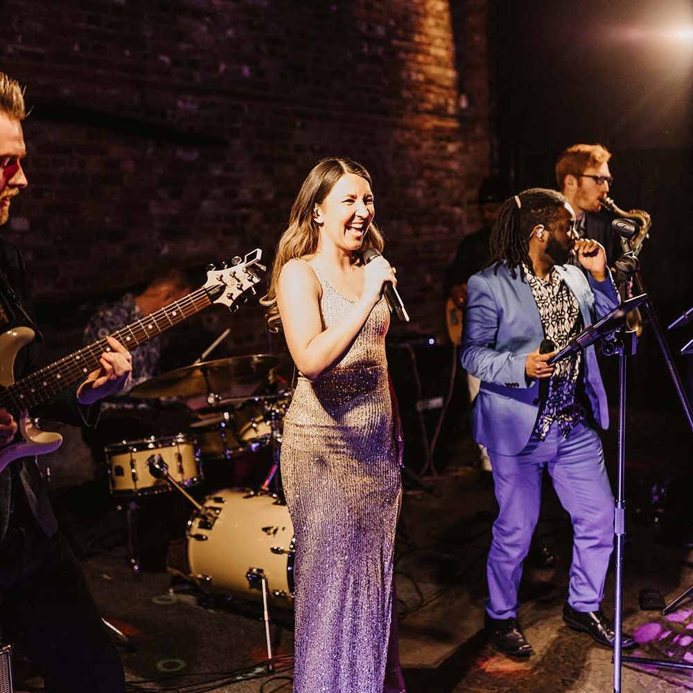Live wedding band entertainment for wedding reception at rustic Cooling Castle Barn venue