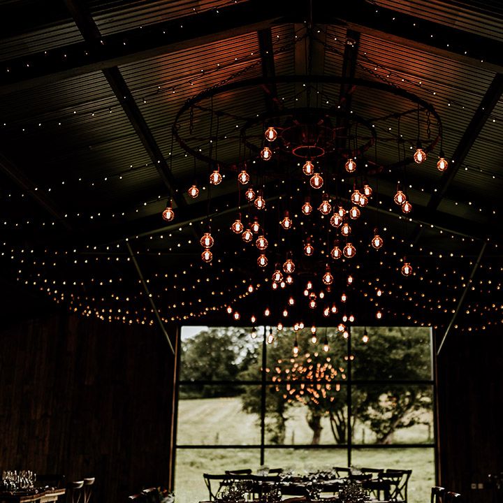 Cosy barn wedding venue at Silchester Farm with fairy lights and low lighting 