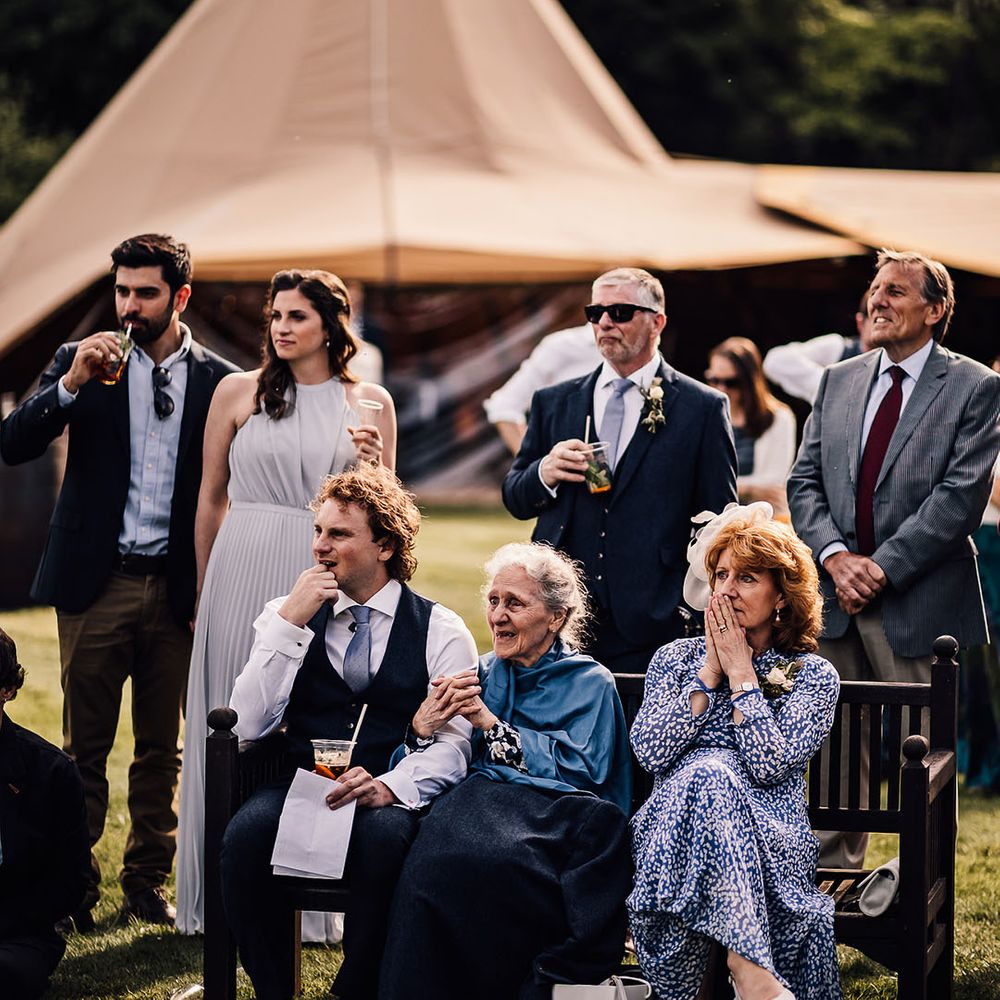Wedding guests listen to wedding speeches