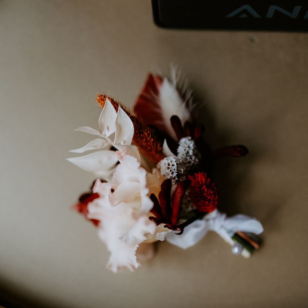 Red, orange and white dried flower decorations with peonies and pampas grass 