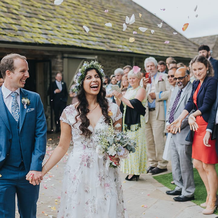 Confetti moment at The Tithe Barn Bolton Abbey with Indian bride in a Savin London Amelia dress and groom a blue suit