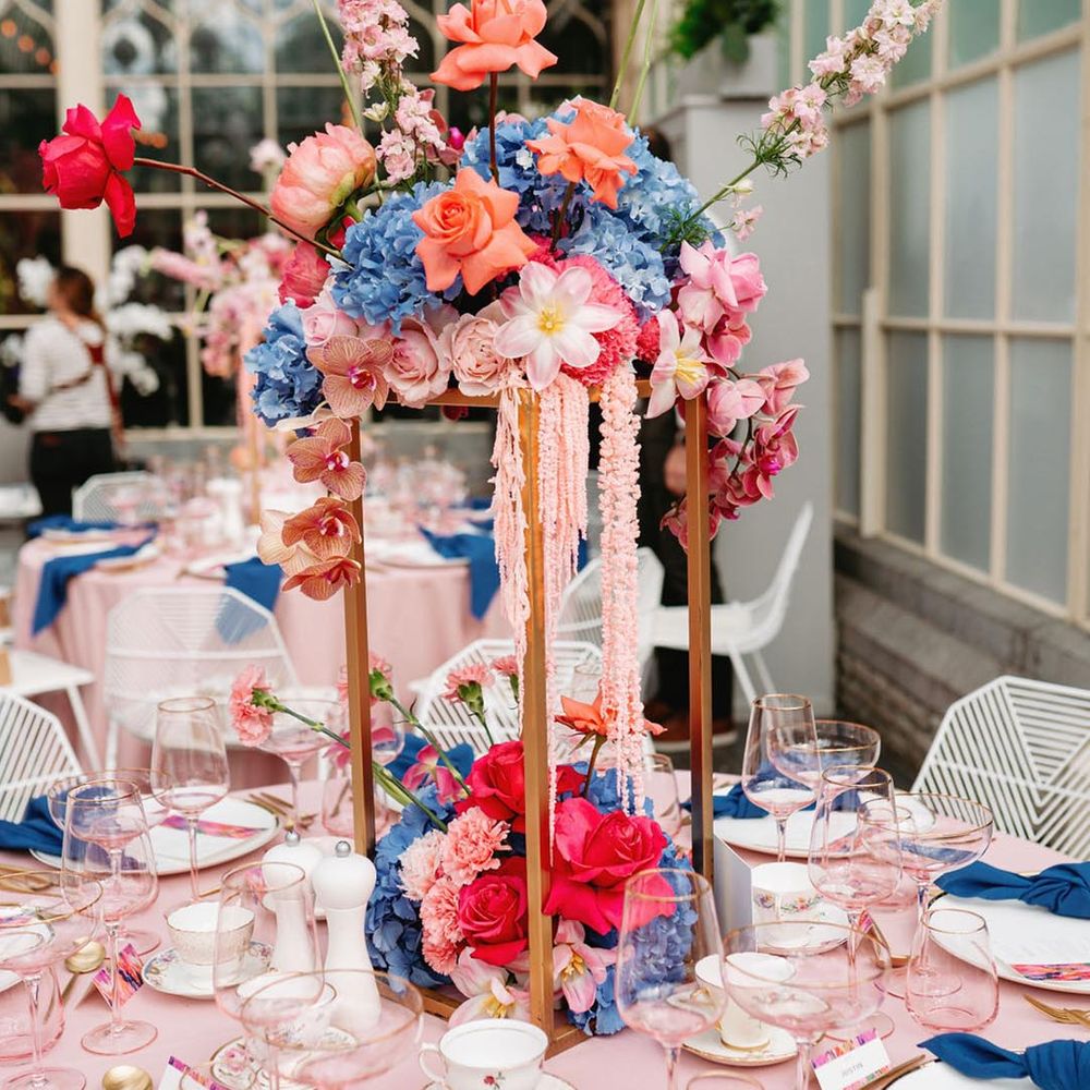 Botanical wedding table centrepieces with hydrangeas, roses, orchids, reflexed tulips and carnations 