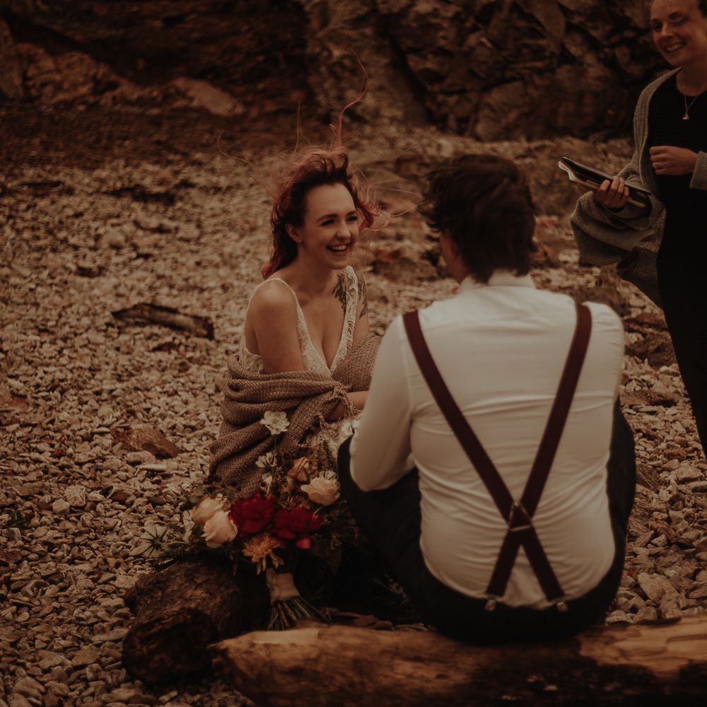 Groom in shirt and braces for beach elopement