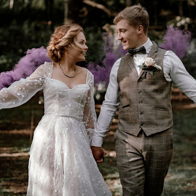 Bride and groom waving smoke bombs in Sherwood Glade woodland wedding
