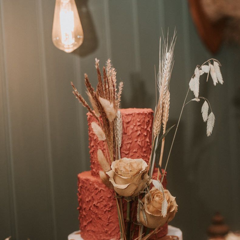 Red three tier wedding cake with textured icing by Bake to the Future
