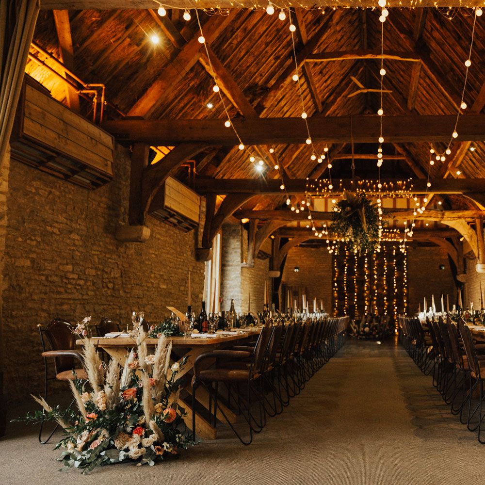 Interior at Tythe Barn wedding with boho decor, fairy lights and candles