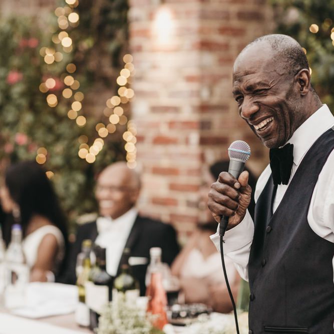 Father of the groom wedding speech in a black waistcoat and bow tie 