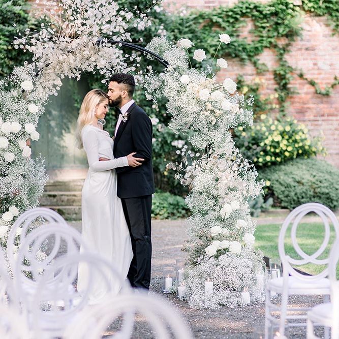 Bride and groom embracing at a sophisticated summer wedding at Garthmyl wedding venue 