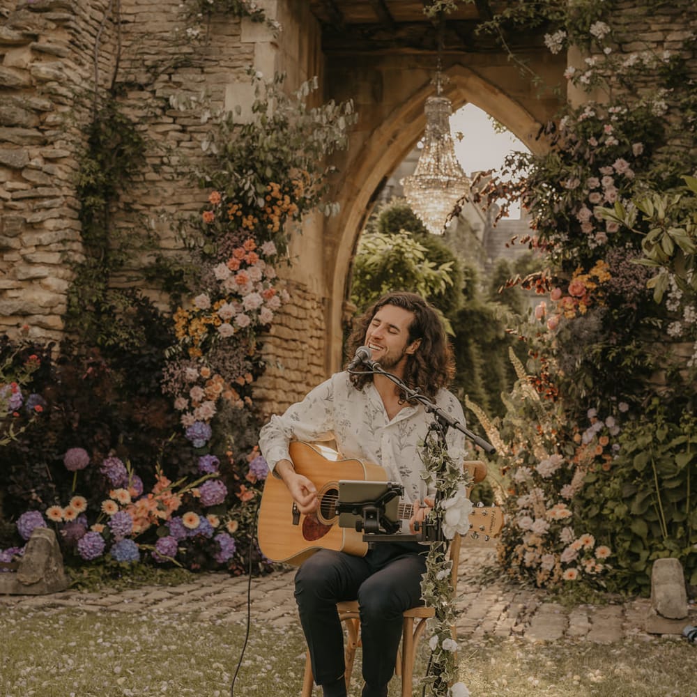 Musician playing his guitar and singing at an outdoor wedding at Euridge Manor 