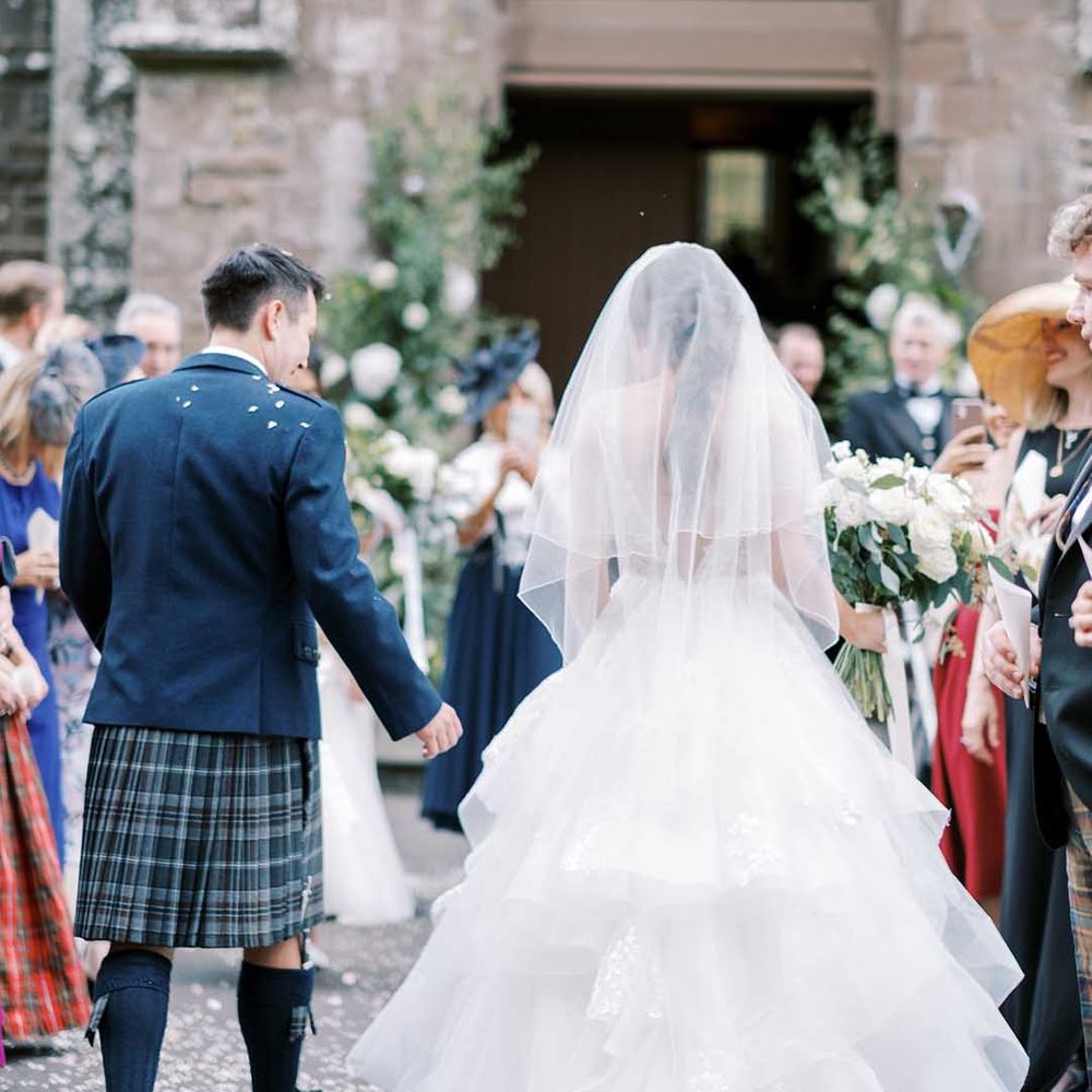 Classic Scottish church wedding with bride in a princess wedding dress and groom in a tartan kilt