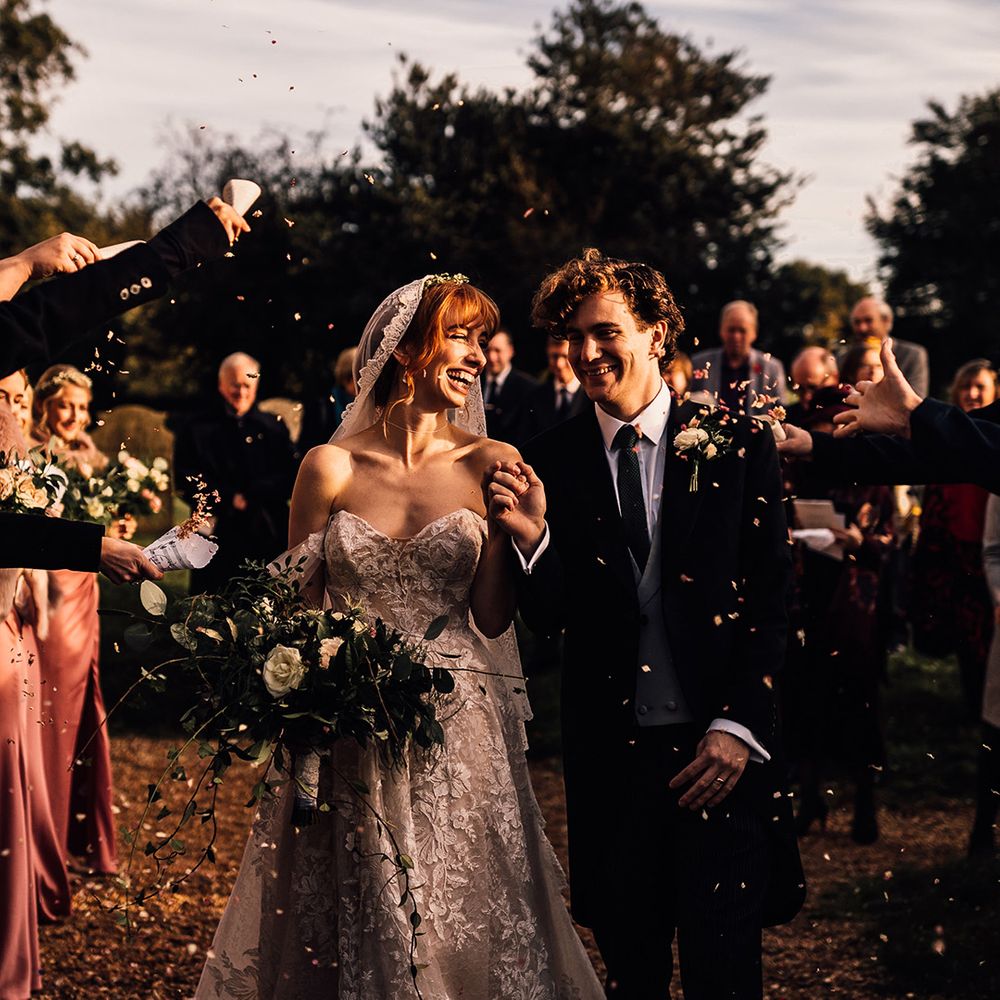 Martini Liana wedding dress for bride during confetti moment with groom