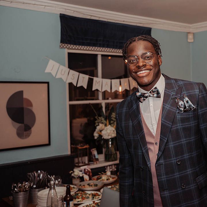 Groomsmen wears tartan suit on wedding day