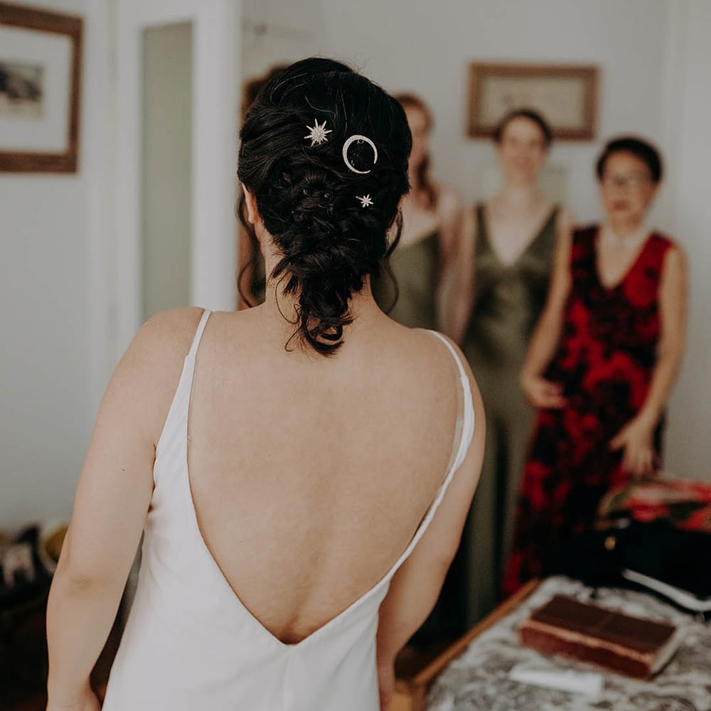 Bride wears her dark hair pulled back into stylish up do featuring silver hair accessories  | Irene Yap Photography