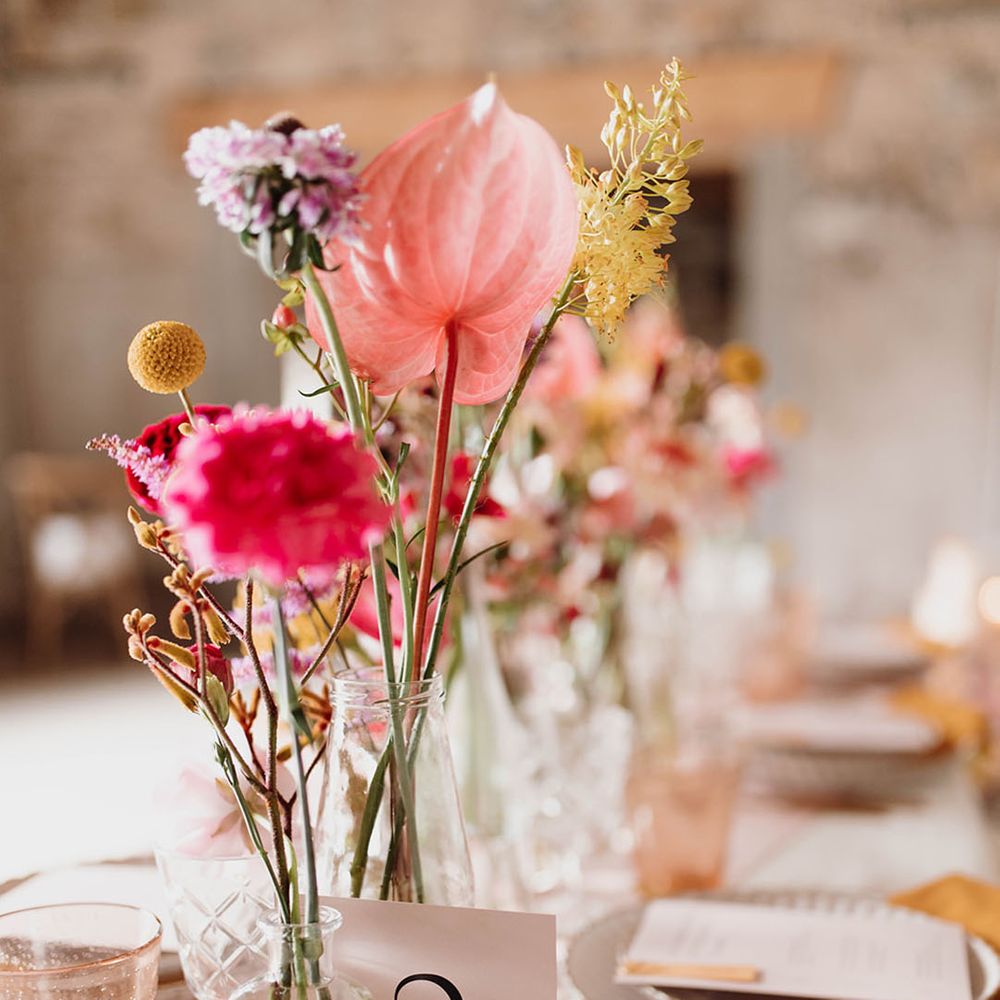 Pink and yellow for stems in bottles wedding table decor 