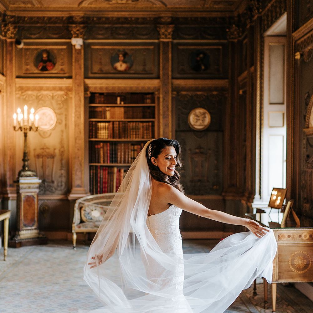 Bride twirls and throws her cathedral veil out to the side 