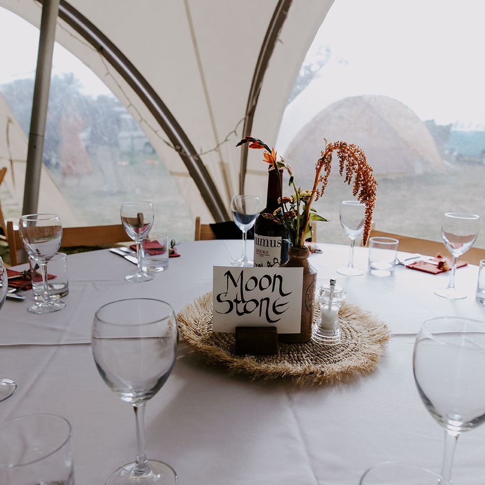 Marquee wedding reception complete with DIY table name signage and dried floral arrangements 
