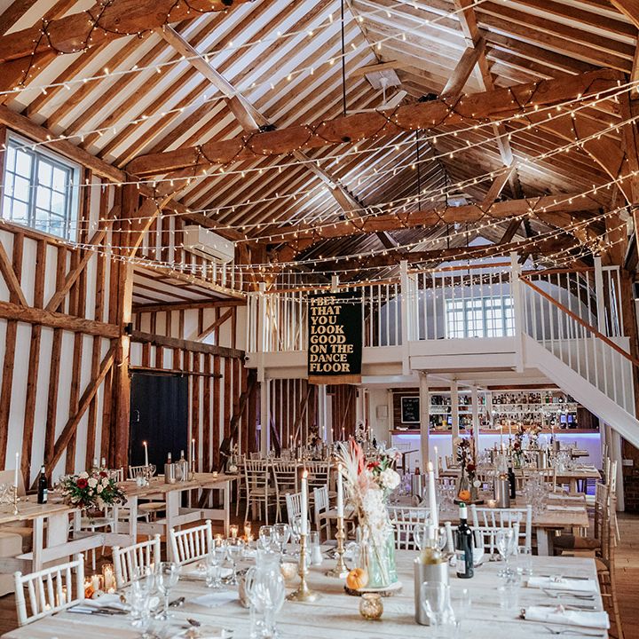 Rustic Milling Barn wedding venue in Hertfordshire with fairy lights and wedding banner decor 