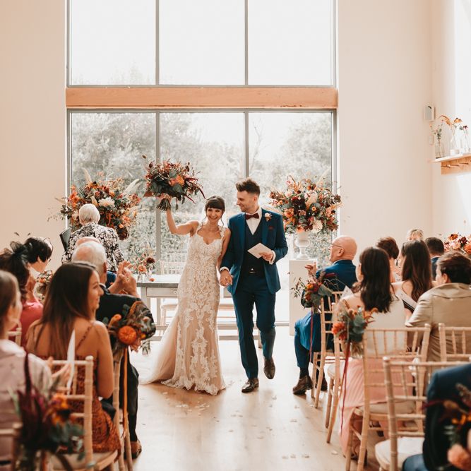 Bride and groom just married at Millbridge Court wedding with Autumn wedding flowers