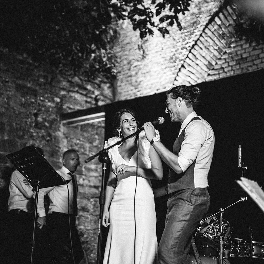 Bride and groom singing on stage